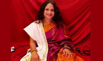 Sadhana Yogalakshmi seated in a traditional saree